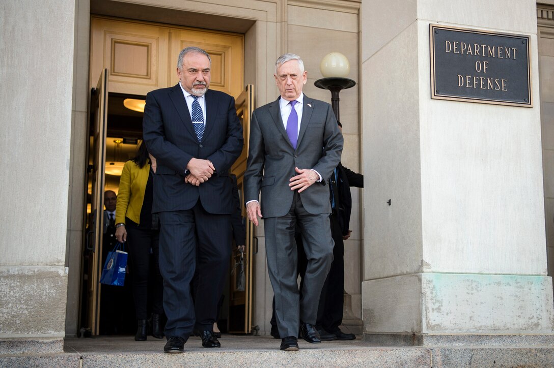 Defense Secretary James N. Mattis walks with Israeli Defense Minister Avigdor Lieberman outside a Pentagon entrance.