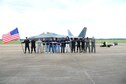 Eight Delayed Entry Program recruits, two Air Force recruiters and the Air Combat Command F-22 Raptor Demonstration team stand in front of an F-22 during 2018 Wings Over Columbus Air and Space Show April 21, 2018, at Columbus Air Force Base, Mississippi. The recruits took the oath of enlistment, administered by Maj. Paul Lopez, ACC F-22 Demonstration team pilot, during the air show. (U.S. Air Force photo by Airman 1st Class Beaux Hebert)