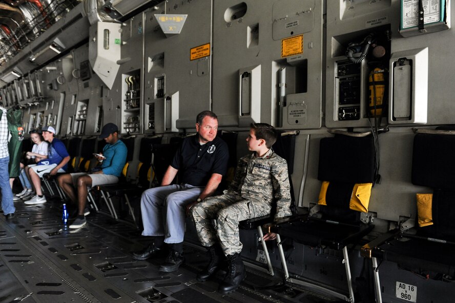 Jeff Chamblee and his son, Jackson, 13, of Tupelo, Mississippi, talk to each other inside of a C-17 Globemaster III during the Wings Over Columbus Air and Space Show on Columbus Air Force Base, Mississippi. Over 15 static displays showed aircraft of all kinds during Saturday’s airshow, including the C-17. (U.S. Air Force photo by Tech. Sgt. Christopher Gross)