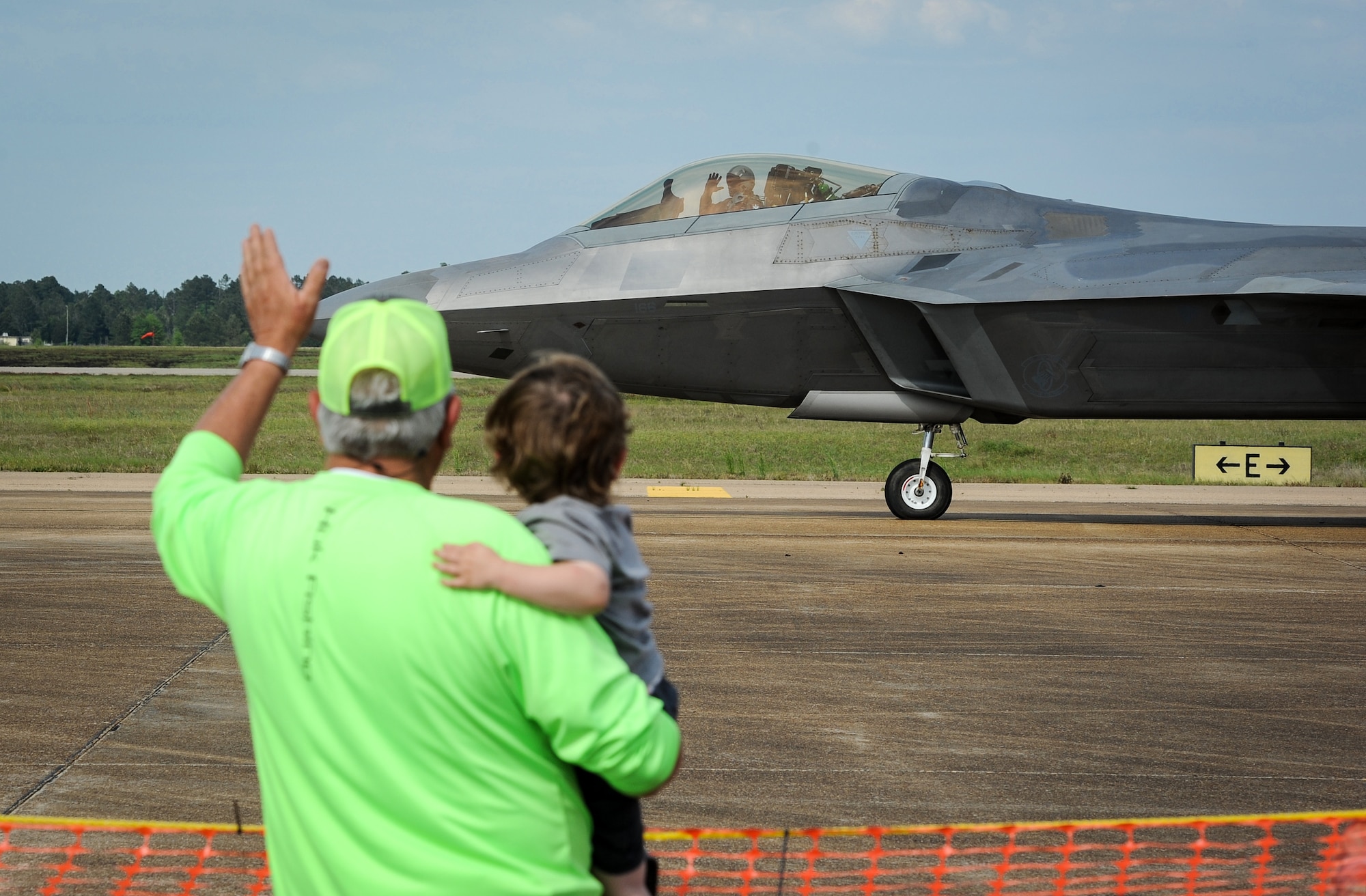 Maj. Paul Lopez, Air Combat Command F-22 Demonstration Team pilot, waves at spectators at Columbus Air Force Base, Mississippi, April 21, 2018, as he taxis out to begin his performance during the Wings Over Columbus Air and Space Show. (U.S. Air Force photo by Tech. Sgt. Christopher Gross)