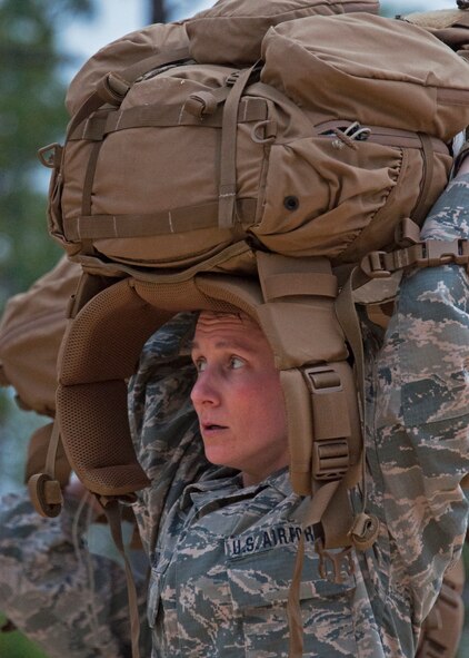 Senior Airman Ashley Conrad, 919th Special Operations Security Forces Squadron, hoists her 45-pound rucksack during her squadron's unit training assembly ruck march