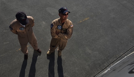 Matt Quiy, left, pilot, and Roger Van Ranst, right, flight mechanic, stand by the B-25J “Miss Mitchell,” April 26, 2018, on the flightline at Charleston International Airport.