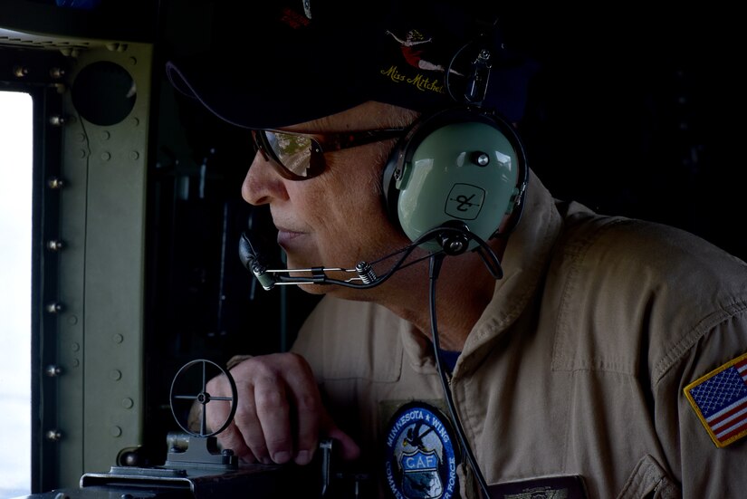 Roger Van Ranst, flight mechanic for the B-25J “Miss Mitchell,” glances out a window of the plane April 26, 2018.