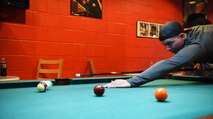 Airman Julian Groft, a 28th Communications Squadron cyber systems operations technician, plays pool as part of the Sexual Assault Awareness race at Ellsworth Air Force Base, S.D., April 20, 2018. April is Sexual Assault Awareness and Prevention Month and Ellsworth AFB is incorporating SAAPM in to Wingman Day to help spread awareness. (U.S. Air Force photo by Airman 1st Class Thomas Karol)