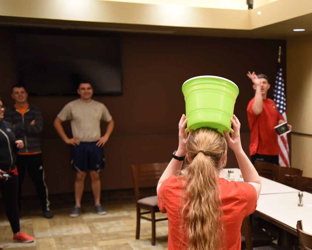 Senior Airman Allison DeFrancesco, a 28th Communications Squadron cyber systems operations technician, tries to catch a marshmallow in a bucket at Ellsworth Air Force Base, S.D., April 20, 2018. April is Sexual Assault Awareness and Prevention Month and the Ellsworth AFB Sexual Assault Prevention Response Office is spreading the word by hosting a race, a difficult discussions forum, a candle light vigil and a luncheon. (U.S. Air Force photo by Airman 1st Class Thomas Karol)