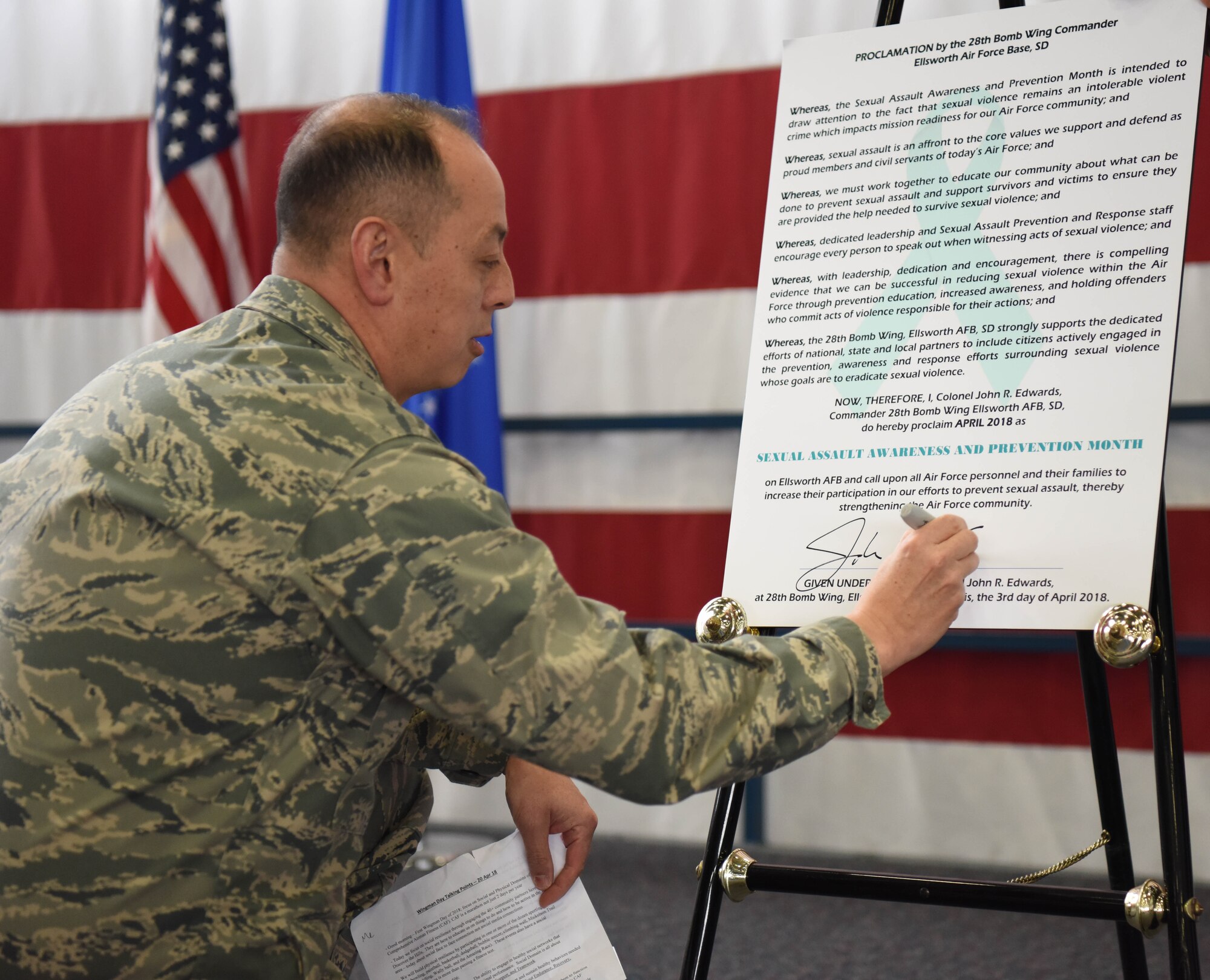 Col. John Edwards, 28th Bomb Wing commander, signs a Sexual Assault Prevention proclamation at Ellsworth Air Force Base, S.D., April 20, 2018. This sexual assault constitution shows that Ellsworth AFB recognizes sexual assault prevention efforts and aids in supporting those affected by it. (U.S. Air Force photo by Airman 1st Class Thomas Karol)