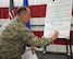 Col. John Edwards, 28th Bomb Wing commander, signs a Sexual Assault Prevention proclamation at Ellsworth Air Force Base, S.D., April 20, 2018. This sexual assault constitution shows that Ellsworth AFB recognizes sexual assault prevention efforts and aids in supporting those affected by it. (U.S. Air Force photo by Airman 1st Class Thomas Karol)