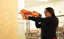Airman 1st Class Shelsea Marble, a 28th Communications Squadron cyber systems operations technician, shoots a toy gun as part of the Sexual Assault Prevention race at Ellsworth Air Force Base, S.D., April 20, 2018. After completing a physical challenge, participants in the Sexual Assault Prevention and Response race had to answer three questions, if they failed to answer the questions they had to pay a physical penalty such as push-ups, sit-ups or squats. (U.S. Air Force photo by Airman 1st Class Thomas Karol)