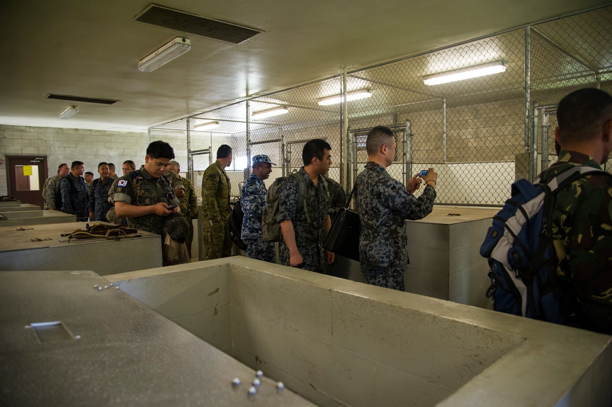PACIFIC DEFENDER 18-2 participants tour the Joint Base Security K-9 unit, Joint Base Pearl Harbor-Hickam, Hawaii, April 10, 2018. PAC DEFENDER 18-2 is a multilateral event intended to enhance strong personal relationships and cooperation with several Asia-Pacific nations.  (U.S. Air Force photo by Tech. Sgt. Heather Redman)