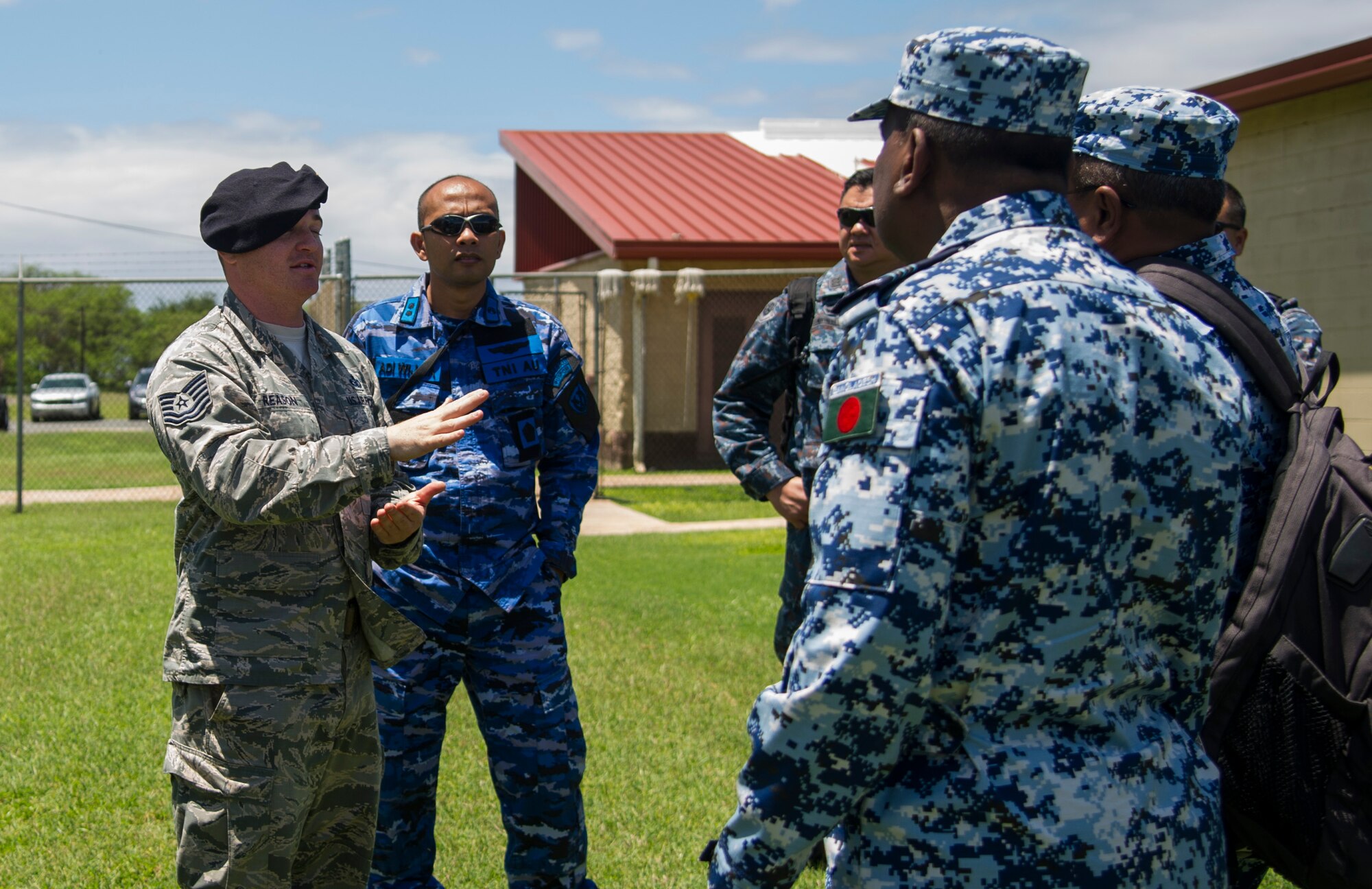 Tech. Sgt. Aaron Reason, Joint Base Security Air Force kennel master, answers questions from PACIFIC DEFENDER 18-2 during a participant’s tour of the Joint Base Security K-9 unit, Joint Base Pearl Harbor-Hickam, Hawaii, April 10, 2018. PAC DEFENDER 18-2 is a multilateral event intended to enhance strong personal relationships and cooperation with several Asia-Pacific nations.  (U.S. Air Force photo by Tech. Sgt. Heather Redman)
