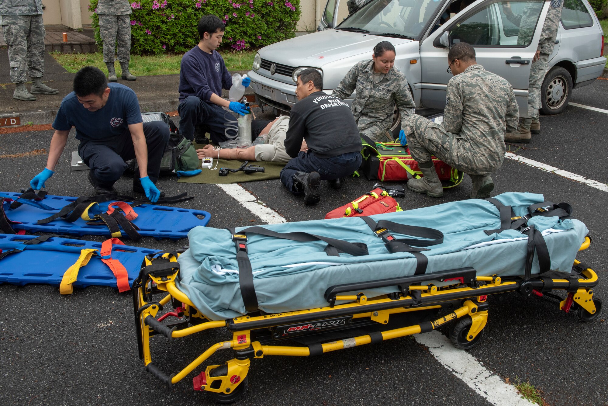 A team of first responders provide care to a simulated pedestrian struck in a vehicle accident during an inter-agency emergency medical response exercise at Yokota Air Base, Japan, April 24, 2018.
