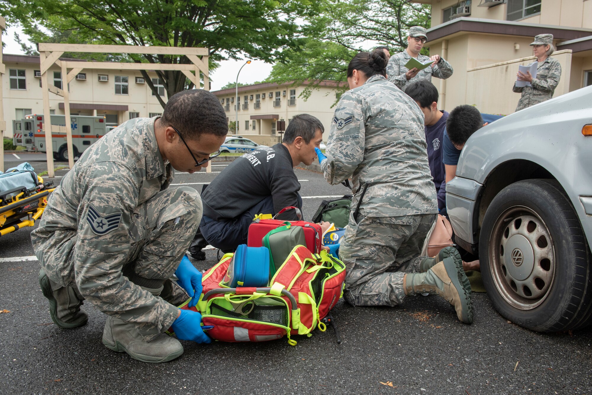 Staff Sgt. Andrew Jones, 374th Medical Group medical technician, searches through his bag for a piece of life-saving equipment during an inter-agency emergency medical response exercise at Yokota Air Base, Japan, April 24, 2018.