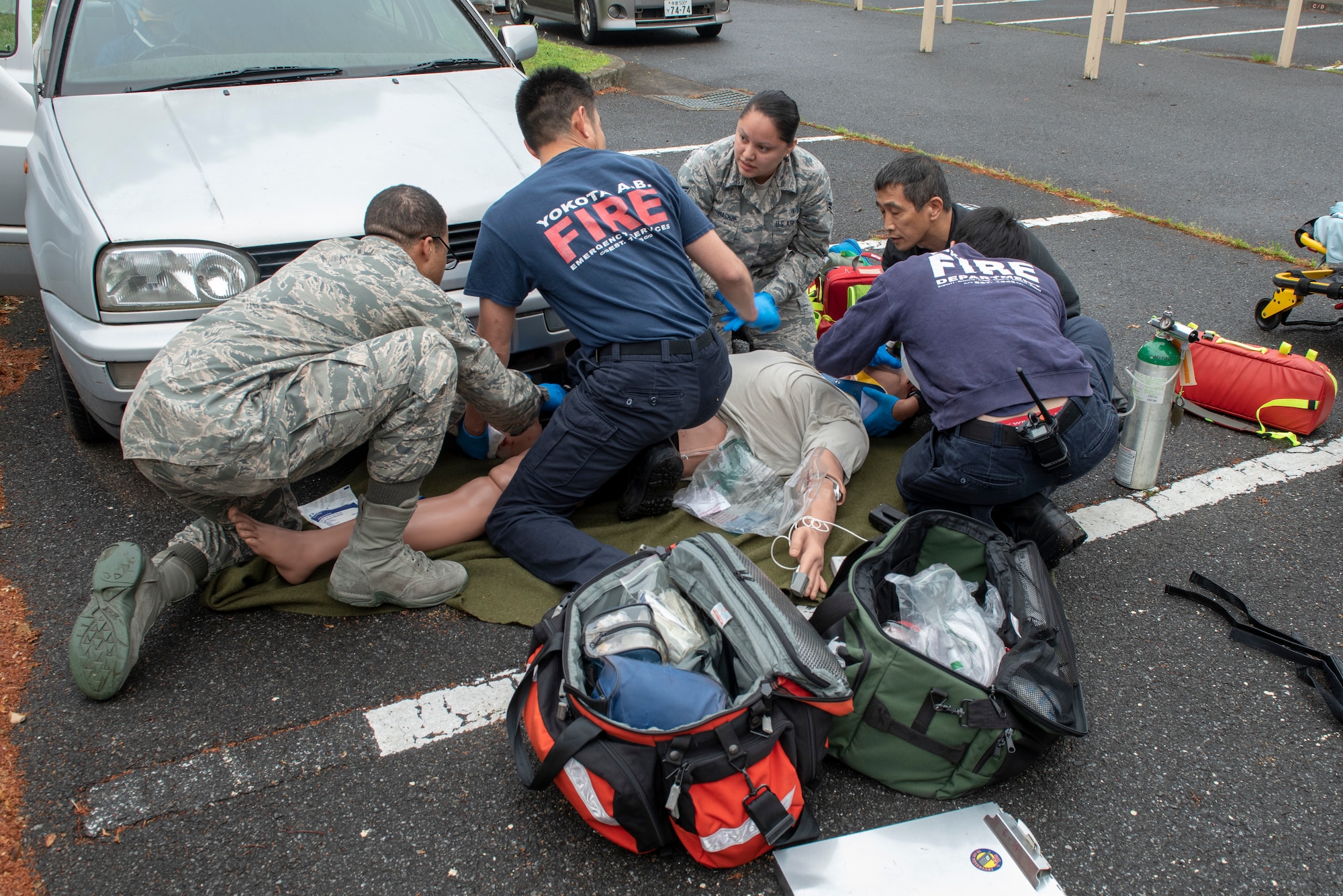 A team of first responders tend to multiple points of trauma on a simulated patient during an inter-agency emergency medical response exercise at Yokota Air Base, Japan, April 24, 2018.