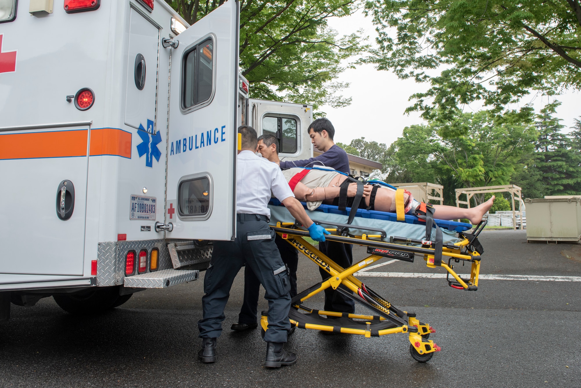 A team of first responders prepare to load a patient into an ambulance during an inter-agency emergency medical response exercise at Yokota Air Base, Japan, April 24, 2018.