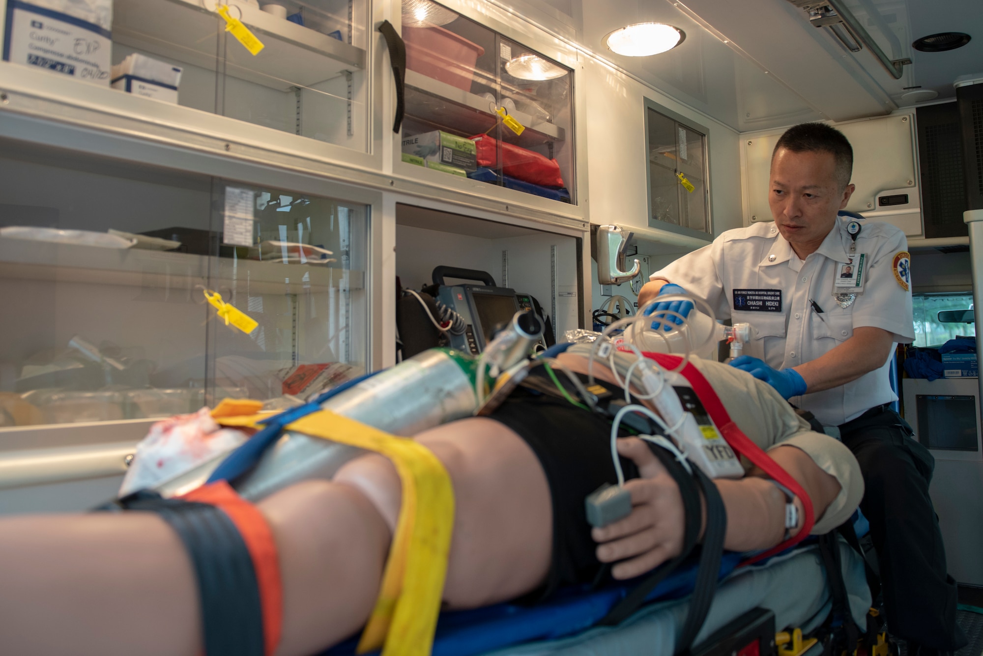 Hideki Ohashi, 374th Medical Group ambulance operator, performs bag-valve-mask ventilation while continuing to monitor patient cardiac rhythm during an inter-agency emergency medical response exercise at Yokota Air Base, Japan, April 24, 2018.