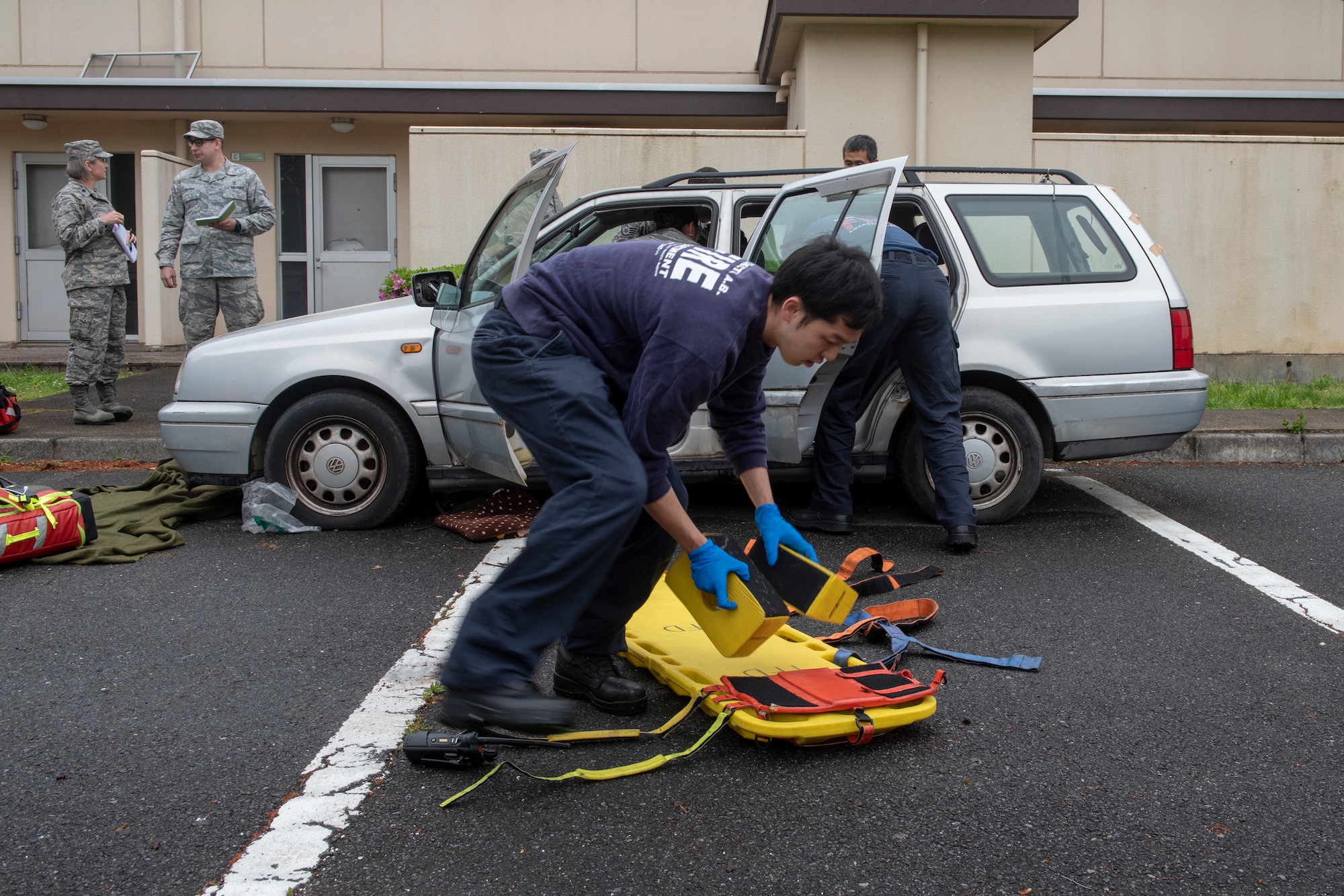 Kento Atari, 374th Civil Engineer Squadron firefighter, retrieves the spine board prior to patient extraction during an inter-agency emergency medical response exercise at Yokota Air Base, Japan, April 24, 2018.