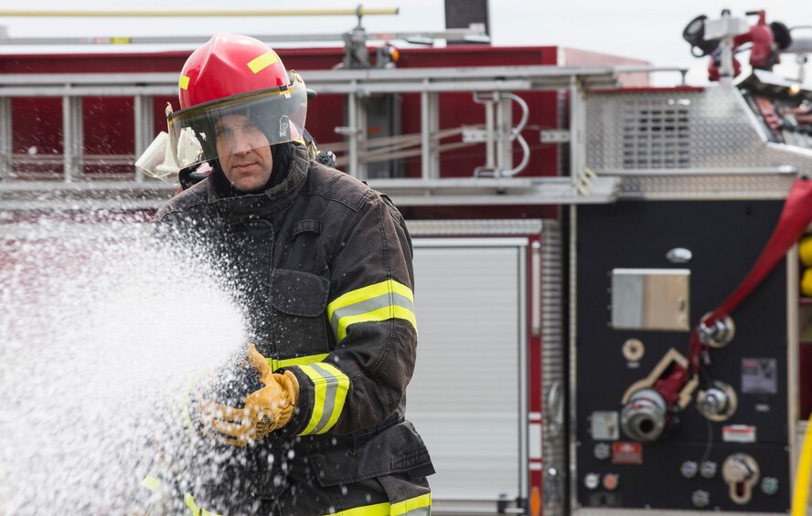 U.S. Air Force Col. Christopher Bromen, 423rd Air Base Group Commander, directs water from a fire hose during a 423rd Civil Engineering Squadron active fire training event at RAF Molesworth, United Kingdom, April 23, 2018. During the event, Bromen had the opportunity to train with the firefighters and observe their specialised skills. (U.S. Air Force photo by Tech. Sgt. Brian Kimball)