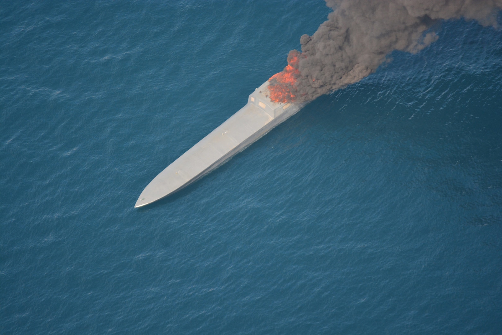 A suspected smuggling vessel on fire in the Pacific Ocean.