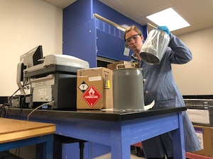 Ainsley Allen, lab chief for the Air Force Petroleum Office’s fuel laboratory at Vandenberg Air Force Base, California, receives samples for testing. The lab tests propellants and gases used on the rockets and analyzes them for contaminants and particles that could interfere with spacecraft operations.