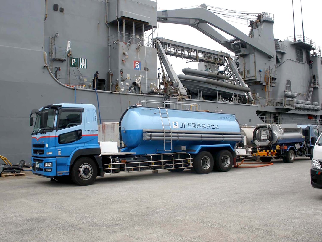 A truck from Japan Iron Engineering waits by the pier at U.S. Fleet Activities Yokosuka, Japan, to transport hazardous materials to a facility for disposal, treatment or storage.