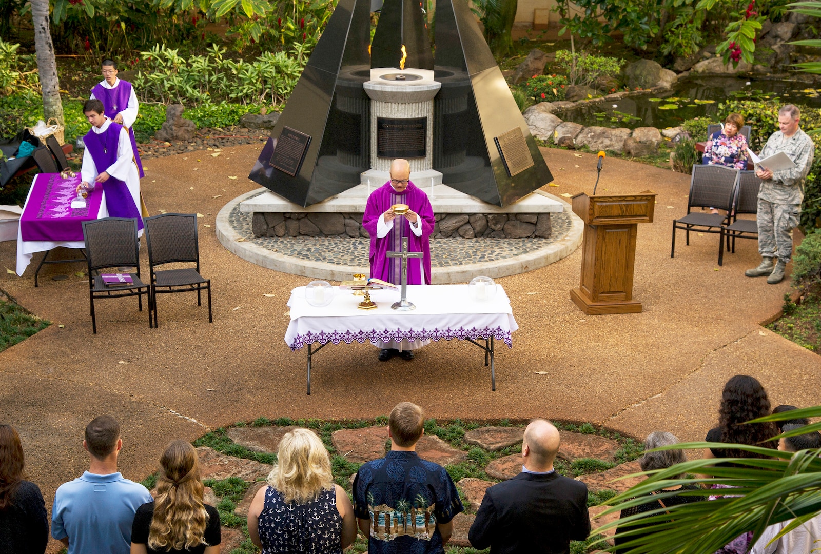 Navy Capt. John Shimotsu, U.S. Pacific Command Catholic chaplain, celebrates Mass at the Courtyard of Heroes during a remembrance ceremony at Joint Base Pearl Harbor-Hickam, Hawaii.