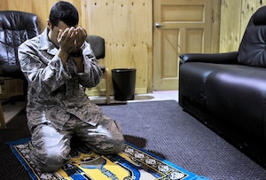 Air Force Staff Sgt. Edger Gaitan, Passenger Service NCOIC, 376th Expeditionary Logistics Readiness Squadron, prays in the distinguished visitor suite during his shift at the Passenger Terminal, Transit Center at Manas, Kyrgyzstan.