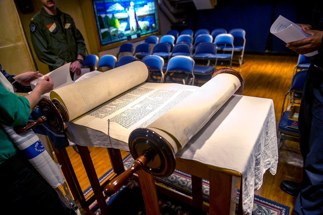 Sailors prepare to read from the Torah during Shavuot Service in the chapel aboard the Nimitz-class aircraft carrier USS George Washington. DLA helps ensure chaplains have the items they need so service members can practice their religious faith wherever they’re stationed.