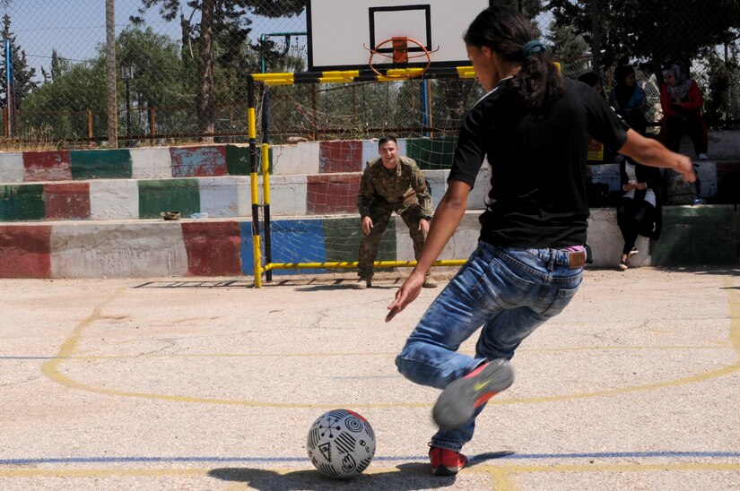 A U.S. Soldier tends goal for a resident of the Amman SOS Children’s Village April 23. The Soldier was part of a donation visit to the village that was arranged by Jordan Armed Forces Imams in coordination with U.S. Chaplains as part of ongoing coordination between the two partner nation militaries. Events like these help to build trust between service members and citizens of different nations.