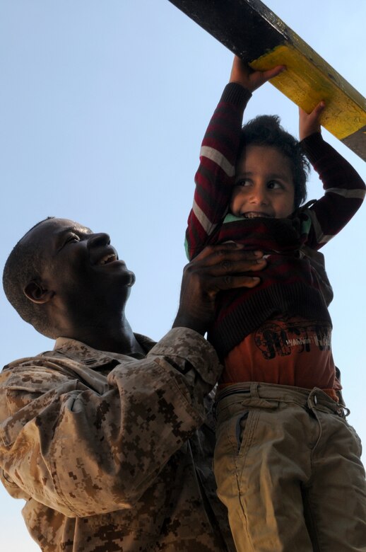 A U.S. Sailor helps a resident of the Amman SOS Children’s Village do pull-ups April, 23. The Sailor was part of a donation visit to the village that was arranged by Jordan Armed Forces Imams in coordination with U.S. Chaplains as part of ongoing coordination between the two partner nation militaries. Events like these help to build trust between service members and citizens of different nations.