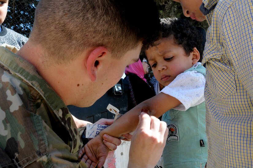 A U.S. Soldier gives a bandage to a resident of the Amman SOS Children’s Village a piggyback April, 23. The Soldier was part of a donation visit to the village that was arranged by Jordan Armed Forces Imams in coordination with U.S. Chaplains as part of ongoing coordination between the two partner nation militaries. Events like these help to build trust between service members and citizens of different nations.