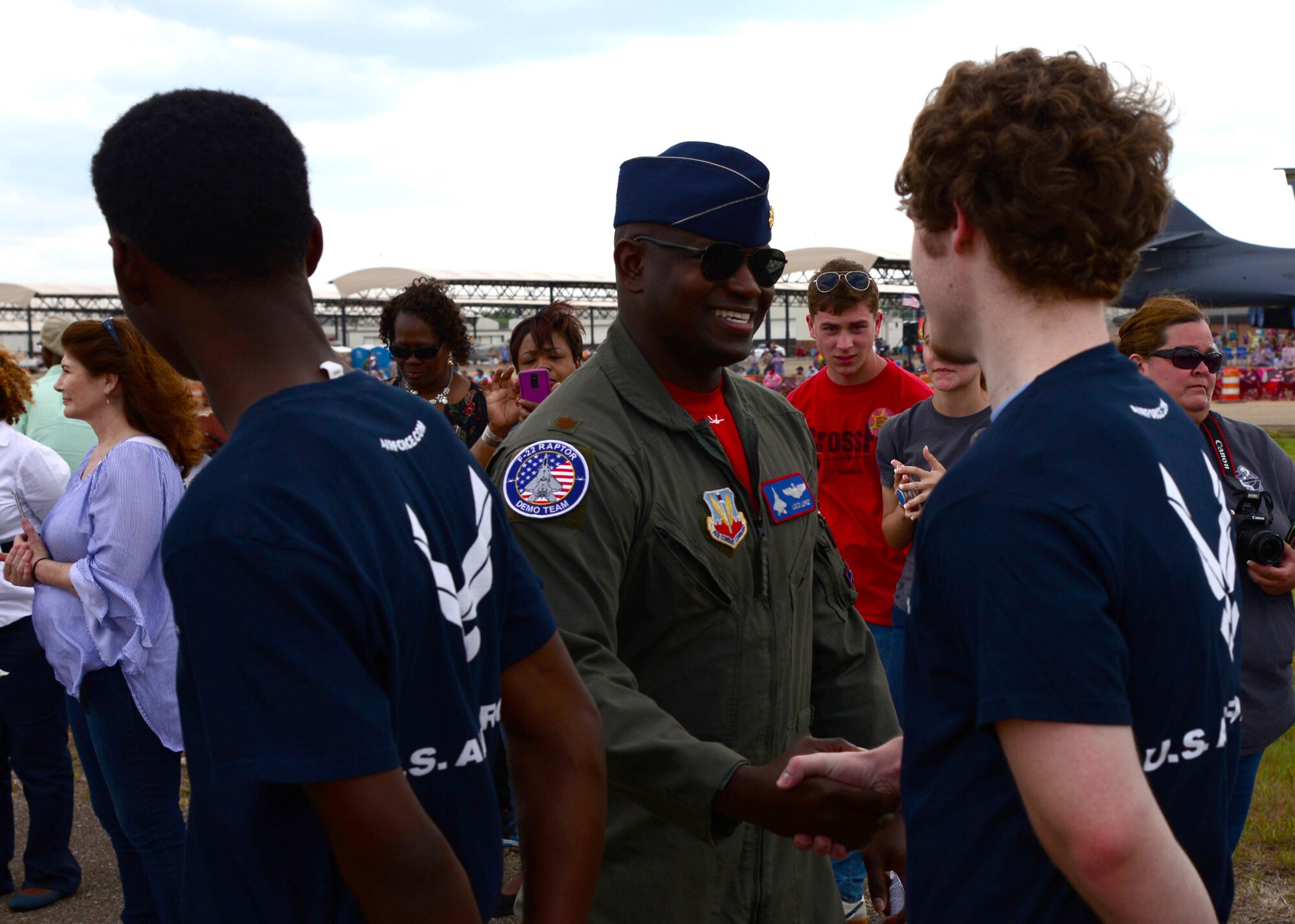 Maj. Paul Lopez, Air Combat Command’s F-22 Demonstration Team pilot, greets Air Force recruits during the 2018 Wings Over Columbus Air and Space Show April 21, 2018, on Columbus Air Force, Base, Mississippi. Lopez administered the recruits’ oath of enlistment during the air show. (U.S. Air Force photo by Airman 1st Class Beaux Hebert)