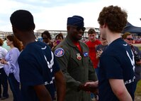 Maj. Paul Lopez, Air Combat Command’s F-22 Demonstration Team pilot, greets Air Force recruits during the 2018 Wings Over Columbus Air and Space Show April 21, 2018, on Columbus Air Force, Base, Mississippi. Lopez administered the recruits’ oath of enlistment during the air show. (U.S. Air Force photo by Airman 1st Class Beaux Hebert)
