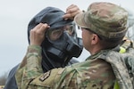 Spc. Logan Lawrence adjusts the Level C suit of U.S. Army Pvt. Brandon Cormeir, both from 3rd platoon, 22nd Engineer Clearance Company, before Cormeir enters the exercise “hot zone” during Guardian Response 18 at Muscatatuck Urban Training Center, Ind., April 22. Lawrence is part of the first team entering the area to provide a 360-degree site characterization. The soldiers are identifying where casualties are and what kind of tools are needed to rescue them.