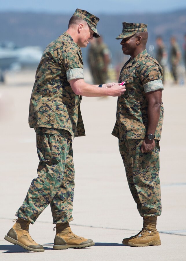 Sgt. Maj. James K. Porterfield, right, receives a Legion of Merit, gold star in lieu of second award, from Maj. Gen. Mark R. Wise, 3rd Marine Aircraft wing commanding general, during Porterfield’s relief and appointment ceremony at Marine Corps Air Station Miramar, Calif., April 20. Porterfield relinquished his post as the 3rd MAW sergeant major to Sgt. Maj. Peter A. Siaw. (U.S. Marine Corps photo by Lance Cpl. Juan Anaya/ Released)