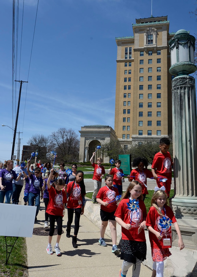 Children lead the way on the Walk for Child Abuse Awareness around the Hart-Dole-Inouye Federal Center.