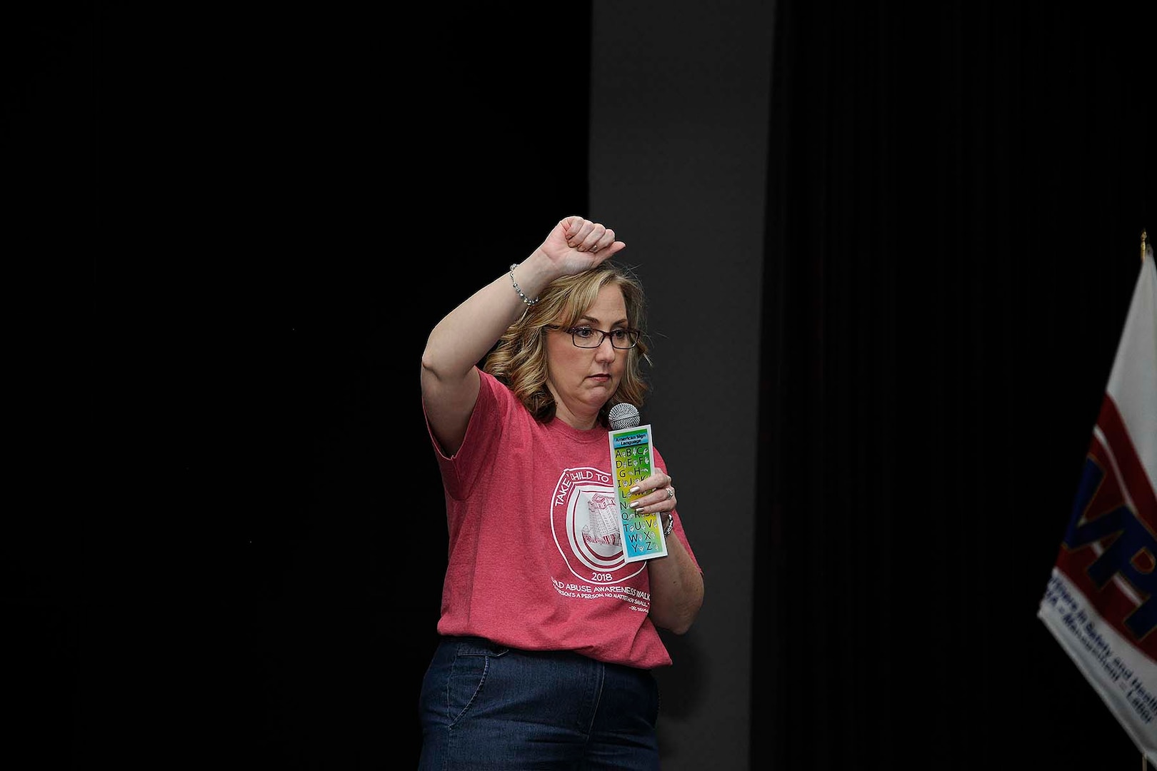 Krista Nawrocki from the Equal Employment Opportunity Office demonstrates sign language to children participating in Bring Your Child to Work Day.