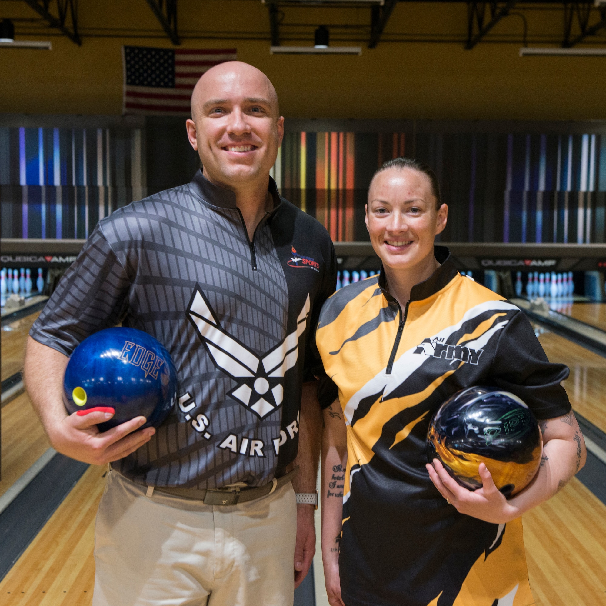 U.S. Air Force Staff Sgt. James McTaggart, assigned to the  Creech Air Force Base, Nev., (left), and U.S. Army Staff Sgt. Rose Aguilar, assigned to Fort Bliss, Texas, right, pose for a photo during the 2018 Armed Forces Bowling Championship at Ten Strike Bowling Center. Mc Taggart and Aguilar were the male and female first place winners of the competition. (U.S. Navy photo by Mass Communication Specialist Seaman Michael DiGabriele/Released)