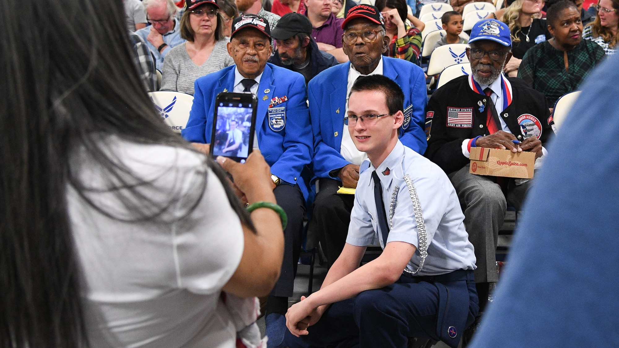 Utah Military Academy Cadet Burningham poses for a photo with Tuskegee Airmen, from left, William Wellborne, Frederick Henry, and Theodore Lumpkin, during an event at Hill Air Force Base, Utah, April 20, 2018. Tuskegee Airman and their families shared their experiences during the event sponsored by the Utah Military Academy, the Aerospace Heritage Foundation of Utah and the Hill AFB Museum. (U.S. Air Force photo by R. Nial Bradshaw)
