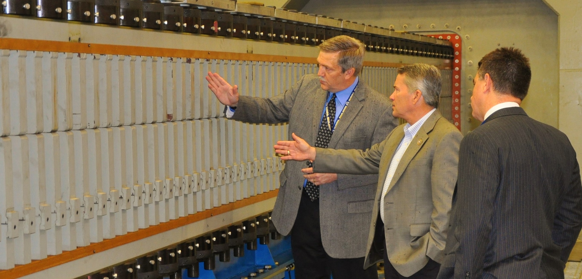 IMAGE: DAHLGREN, Va. (April 24, 2018) - U.S. Rep. Jody Hice, (R-Ga.), center, discusses the laboratory railgun's construction with Chester Petry, electromagnetic railgun lead systems engineer at Naval Surface Warfare Center Dahlgren Division (NSWCDD). Petry described its construction after the congressman witnessed the railgun launcher fire an experimental round at the NSWCDD Potomac River Test Range. Throughout his tour of NSWCDD facilities, Hice - a House Armed Services Committee member - saw the command's capability to develop and integrate complex warfare systems, including the ability to incorporate electric weapons technology into existing and future fighting forces and platforms. Looking on is Dale Sisson, NSWCDD deputy technical director.  (U.S. Navy photo by John Joyce/Released)
