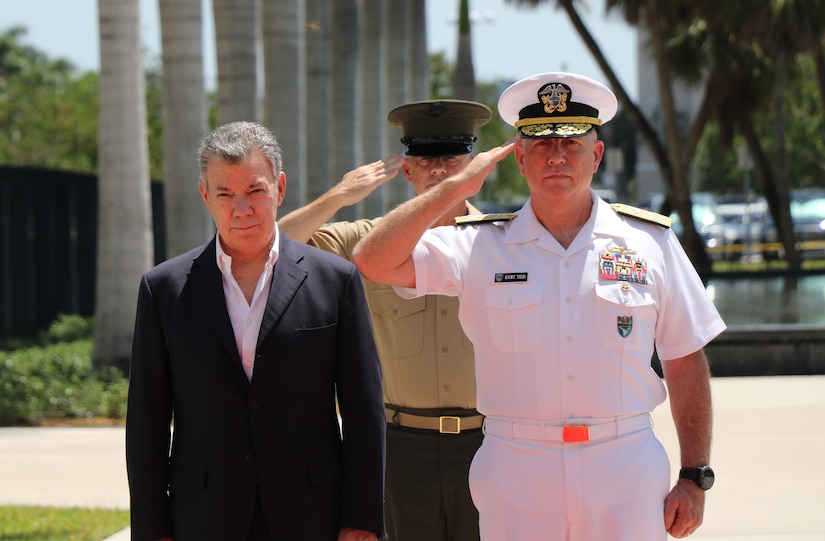 Navy Adm. Kurt W. Tidd, right, commander of U.S. Southern Command, and Marine Corps Sgt. Maj. Bryan Zickefoose, Southcom’s command sergeant major, salute during the playing of the U.S. and Colombian national anthems as Colombian President Juan Manuel Santos, left, listens during a welcoming ceremony at Southcom’s headquarters in Miami.