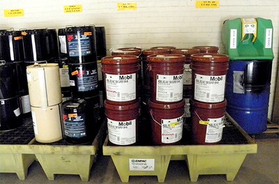 Pallets containing hazardous materials, such as oil and paint, are stored prior to use at the Norfolk Naval Shipyard in Portsmouth, Virginia. A system implemented by DLA now manages hazardous materials at four Naval Sea Systems Command shipyards.