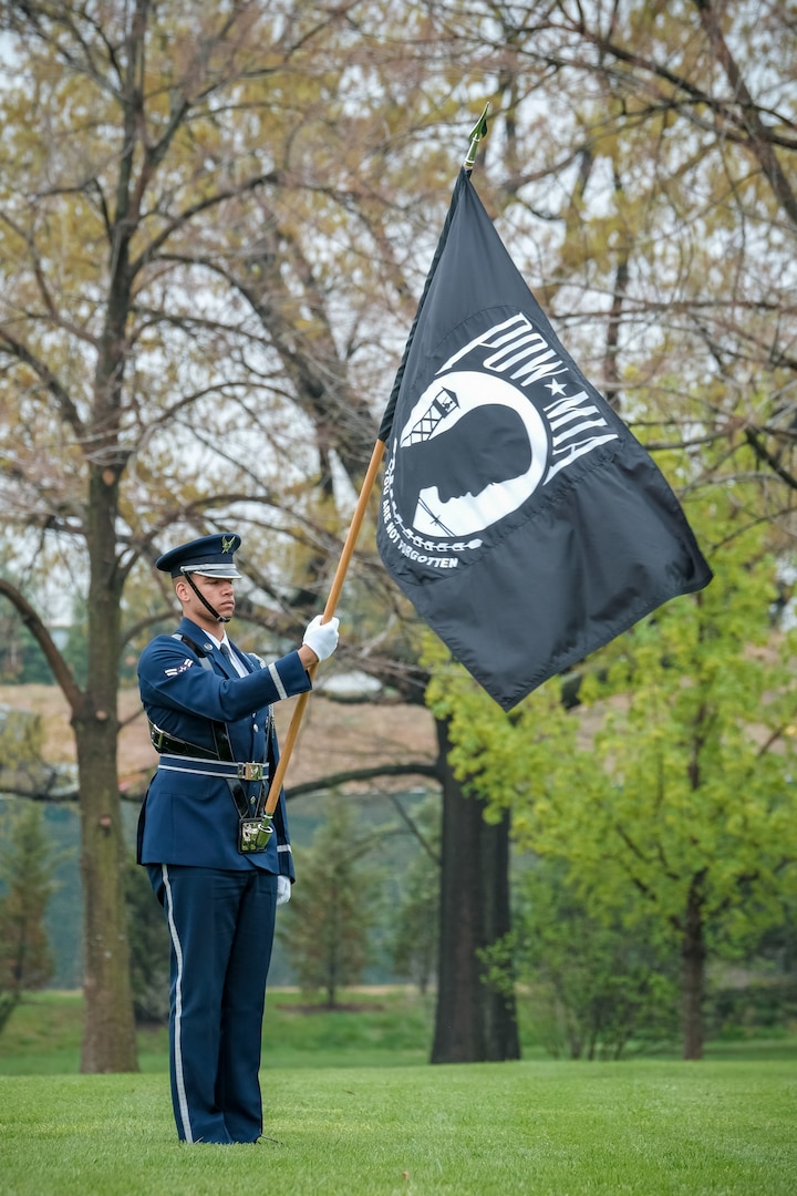 A member of a U.S. Air Force honor guard team holds the POW/MIA  flag during a funeral service held for Air Force Reserve 1st Lt. David T. Dinan, III, on April 25, 2018 at Arlington National Cemetery. Lt. Dinan was shot down and lost in Laos in 1969. DPAA accounted for Lt. Dinan on Aug. 7, 2017 after conducting several investigation missions that led to the recovery of his remains. (DPAA photo by Lee Tucker)