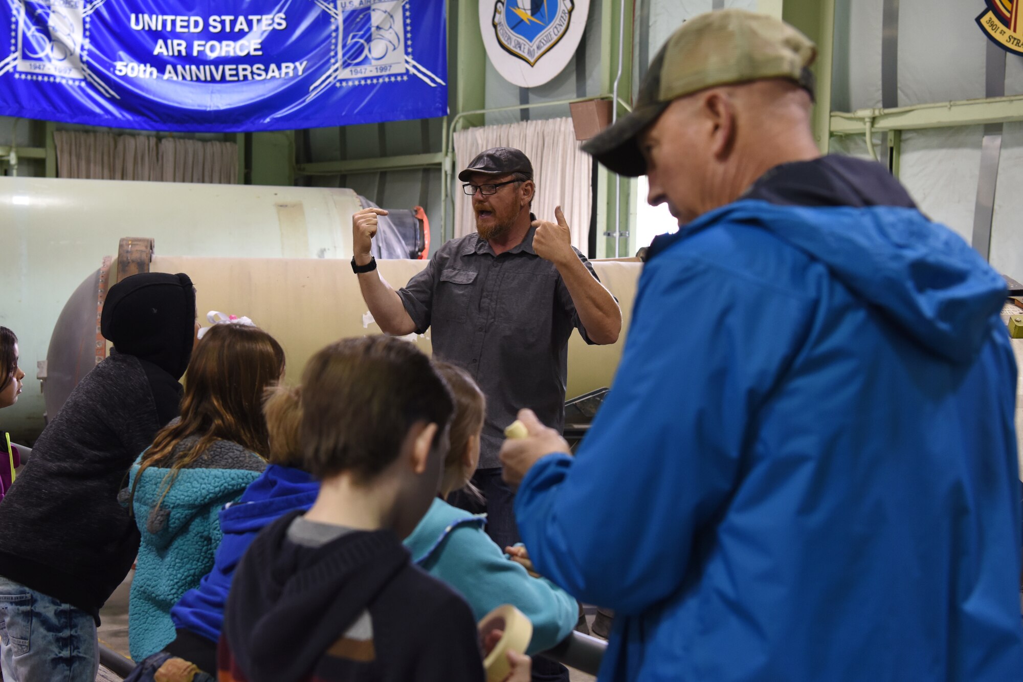 Donald Prichard, Space and Missile Technology Center museum curator, teaches children at the museum during Bring Your Child to Work Day April 26, 2018, Vandenberg Air Force Base, Calif. Prichard organizes events such as these to teach children the basics of the space and missile mission. (U.S. Air Force photo by Airman Aubree Milks/Released)