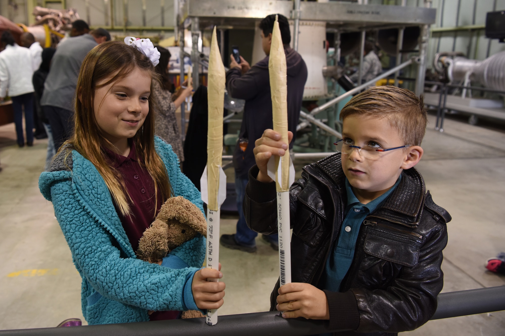 Vandenberg children compare model rockets at the Space and Missile Technology Center during Bring Your Child to Work Day April 26, 2018, Vandenberg Air Force Base, Calif. The event was established to underscore the important role children play in the Armed Forces community. (U.S. Air Force photo by Airman Aubree Milks/Released)