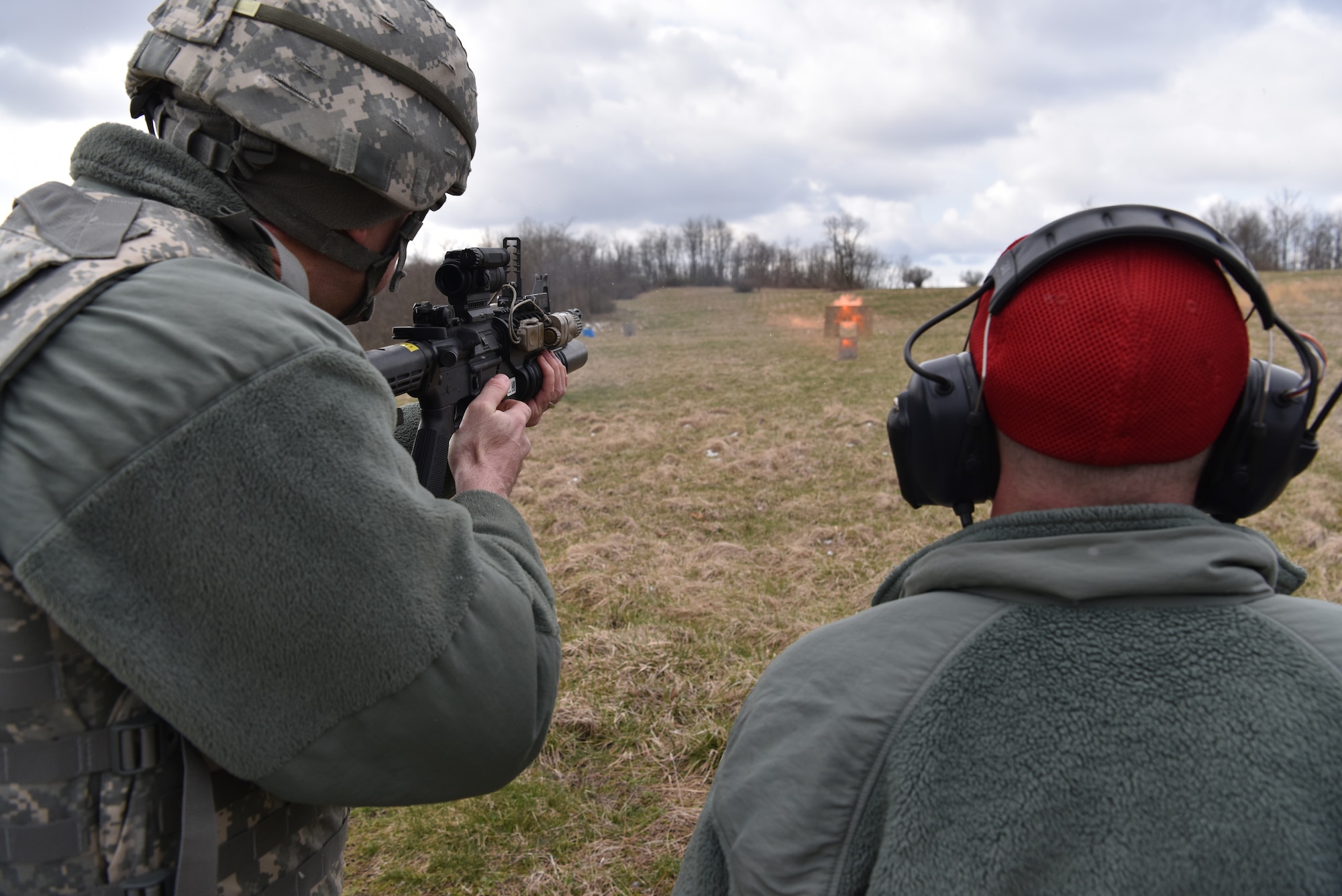 A 911th Security Forces Squadron combat arms training and maintenance instructor, right, observes a 911th SFS member, left, during M203 grenade launcher firing in Burgettstown, Pennsylvania, April 8, 2018. The M203 is a single shot 40mm grenade launcher designed to attach to an M-4 Weapon system. (U.S. Air Force photo by Staff Sgt. Marjorie Bowlden)