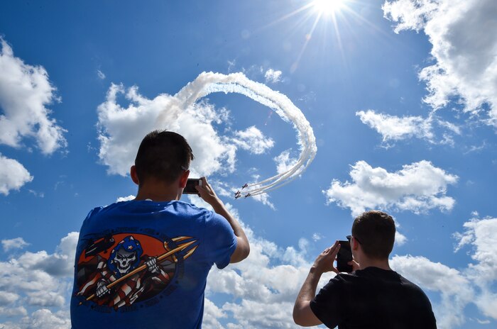 Spectators take photo of an aerial act at the Air and Space Expo rehearsal at Joint Base Charleston, S.C., April 27, 2018.
