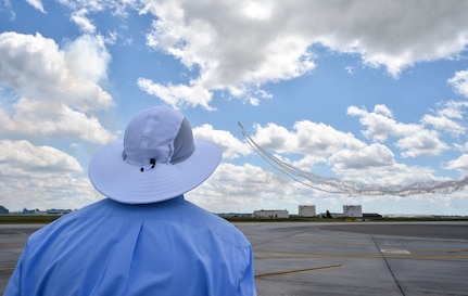 A spectator watches an aerial act during the 2018 Air and Space Expo rehearsal at Joint Base Charleston, S.C., April 27, 2018.