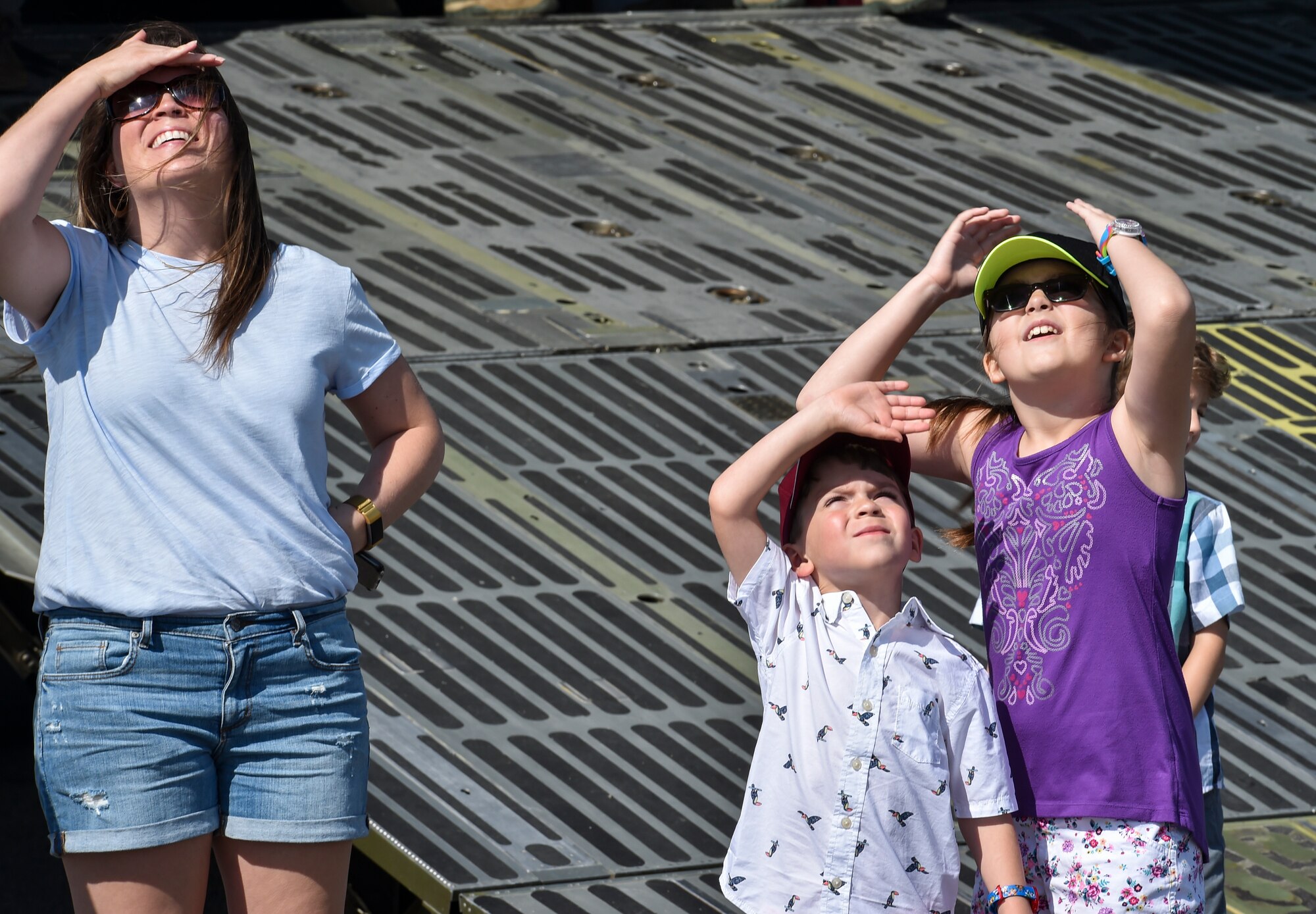 Spectators at the 2018 Air and Space Expo rehearsal watch as an aerial act flies over them at Joint Base Charleston, S.C., April 27, 2018.