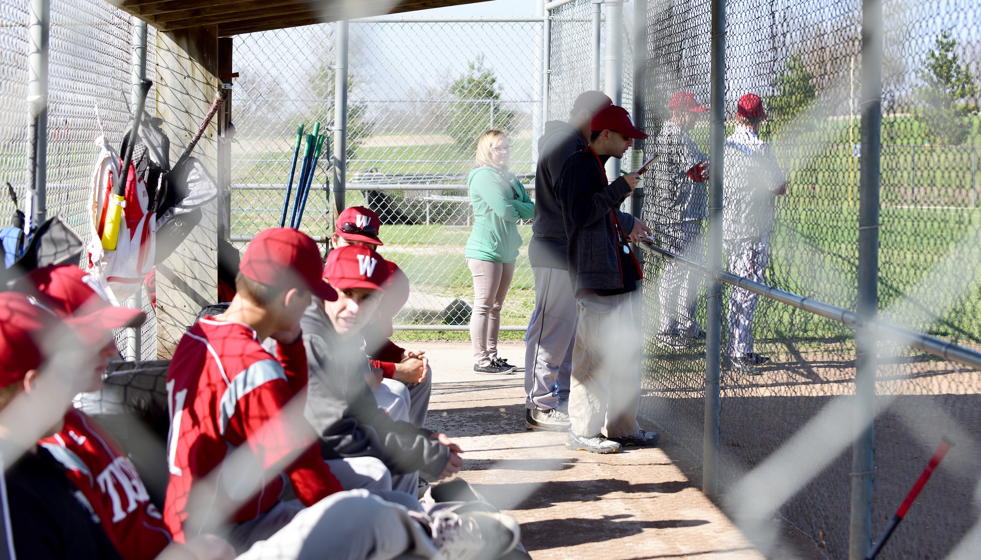 Andy Martins, a manager for the Warrensburg High School baseball team, watches the game at West Park in Warrensburg, Mo., April 16, 2018. Even though he has autism, Andy is a vital member of the team. He ensures the pitchers do not exceed the limit number of throws per game, which is put in place to prevent injury. (U.S. Air Force photo by Staff Sgt. Danielle Quilla)