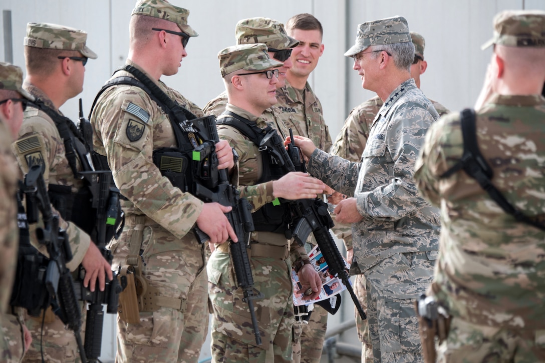 The vice chairman of the Joint Chiefs of Staff shakes hands with service members.